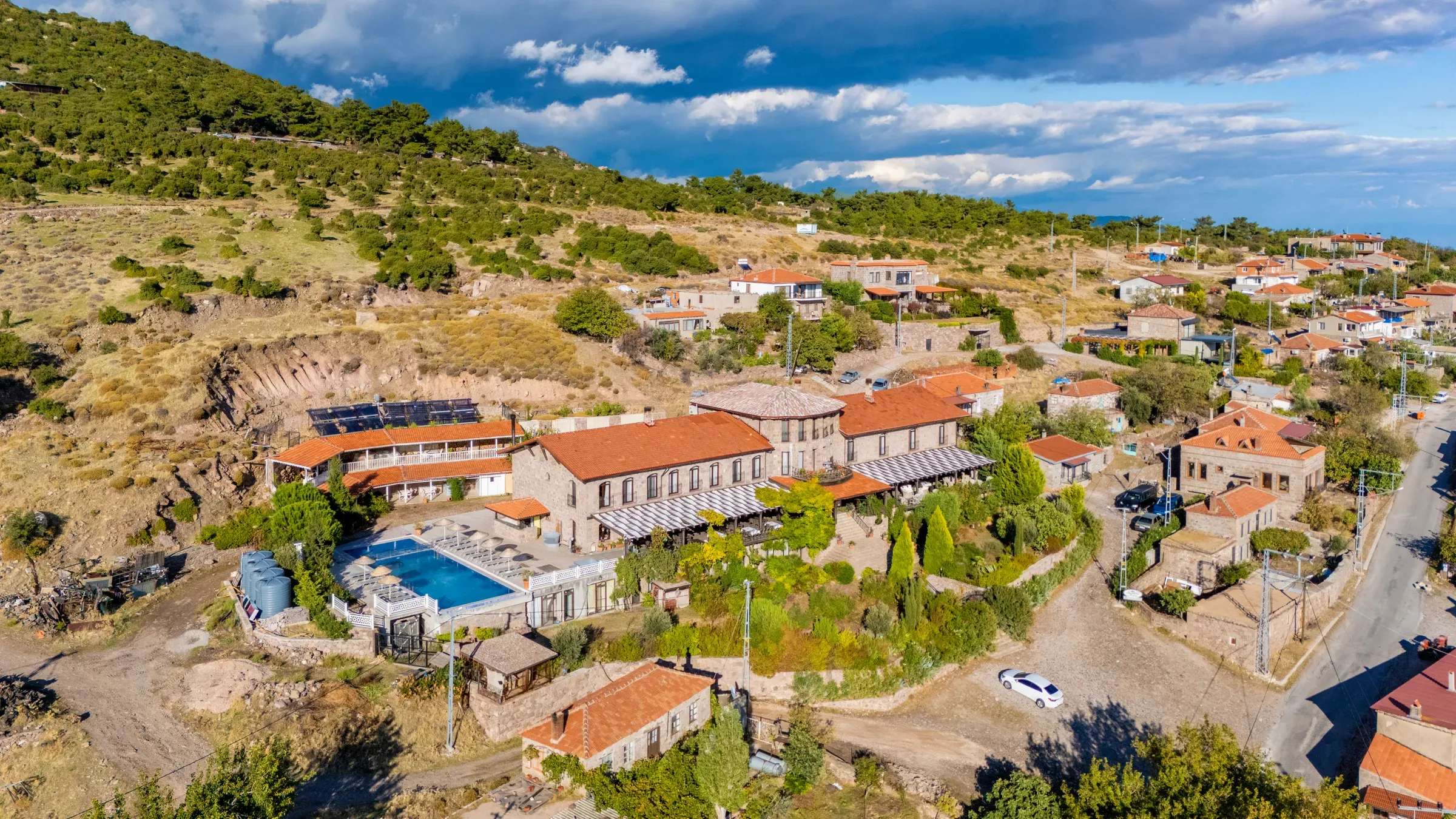 Aerial view of Sunaba Kasrı, its pool and Büyükhusun village
