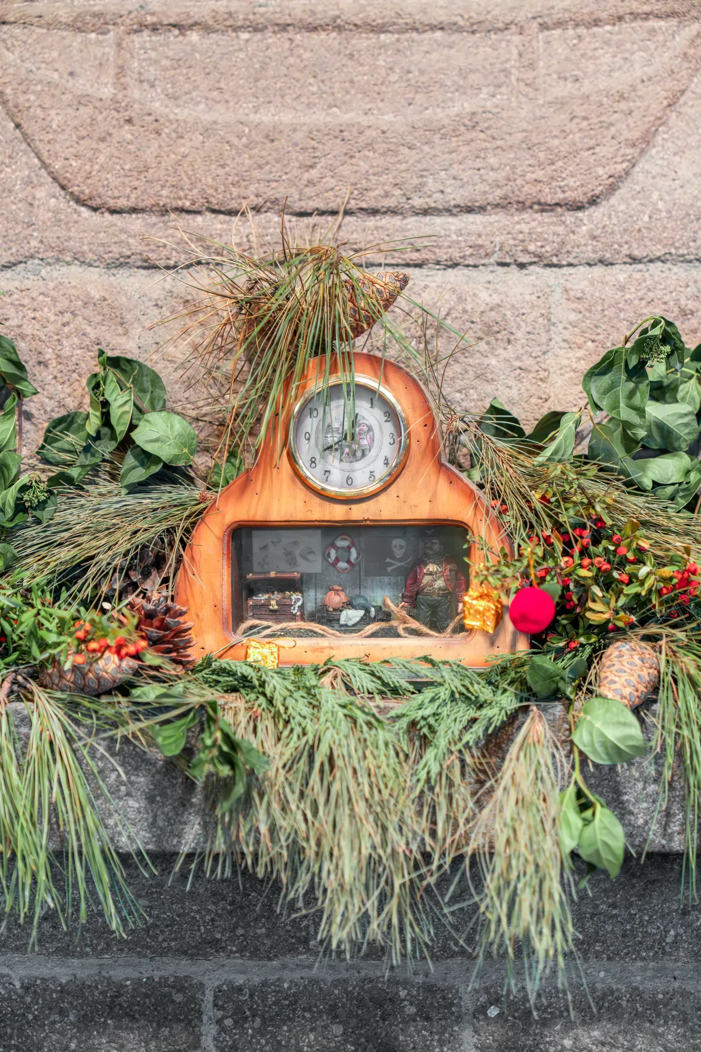 An old mantel clock dressed with greenery